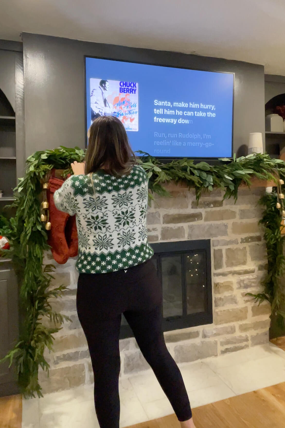 Decorating a fireplace mantel with stockings.